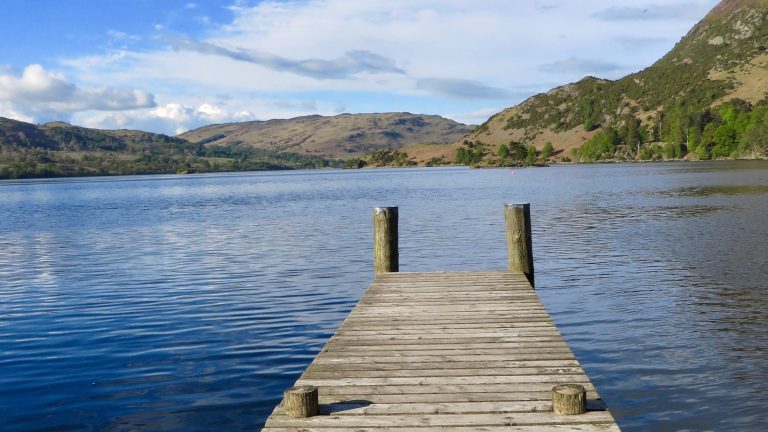 Lake with Single Dock In Mountains